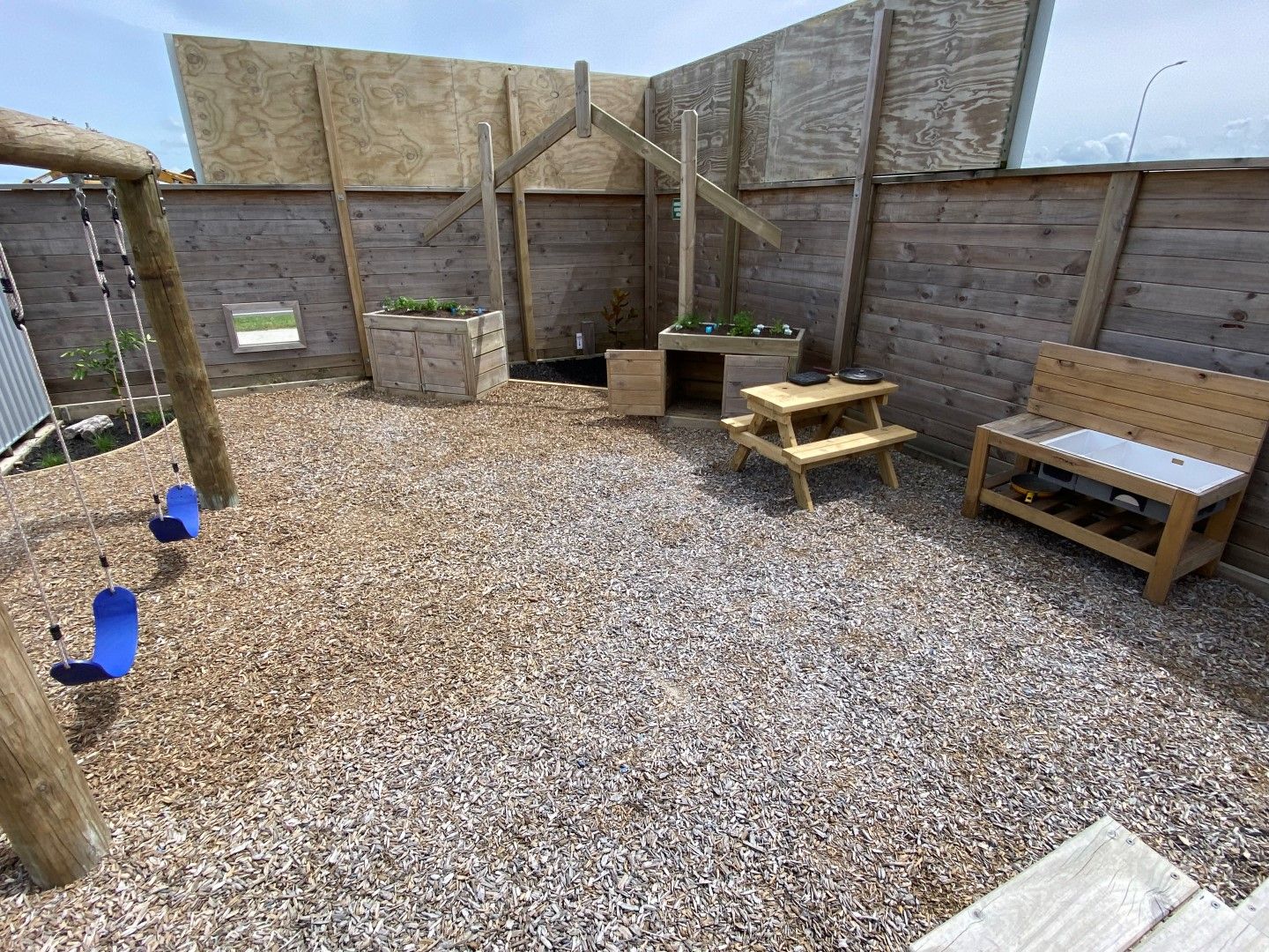 Nurture and Bloom | Outdoor playspace with swings, mud kitchen and vegetable garden