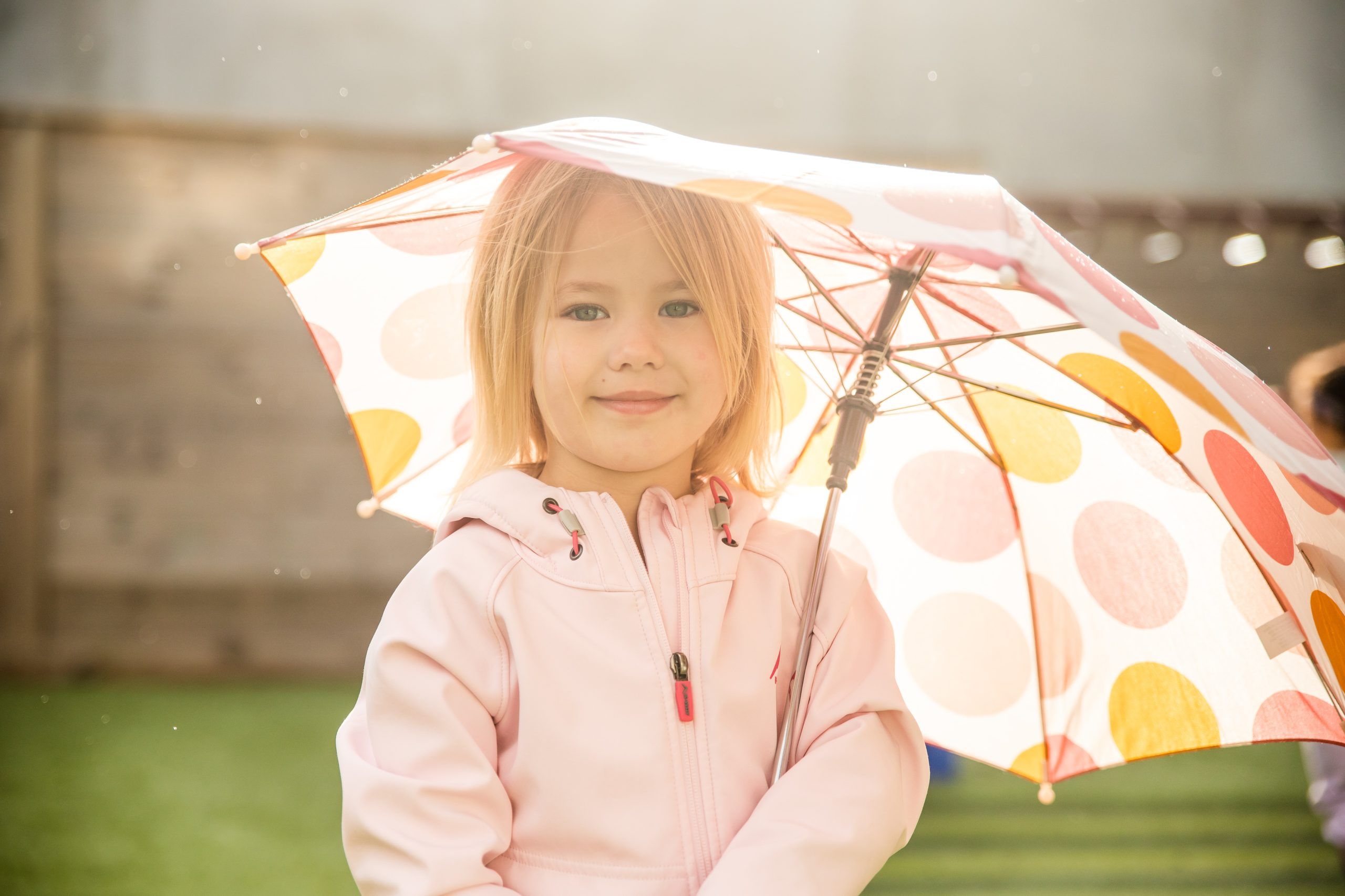 Nurture & Bloom | Child outdoors with umbrella