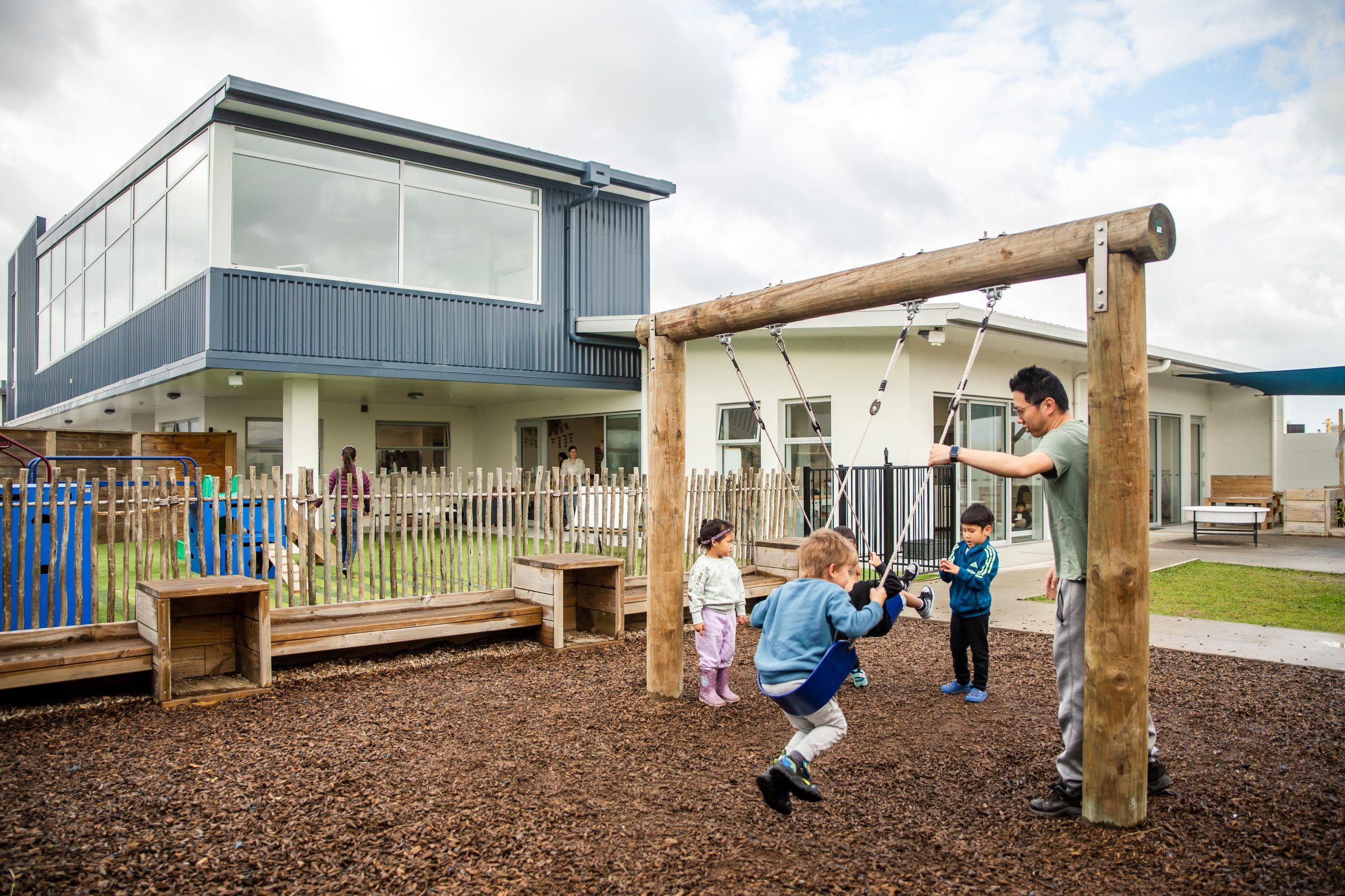 Nurture and Bloom | View of an outdoor playspace with swing