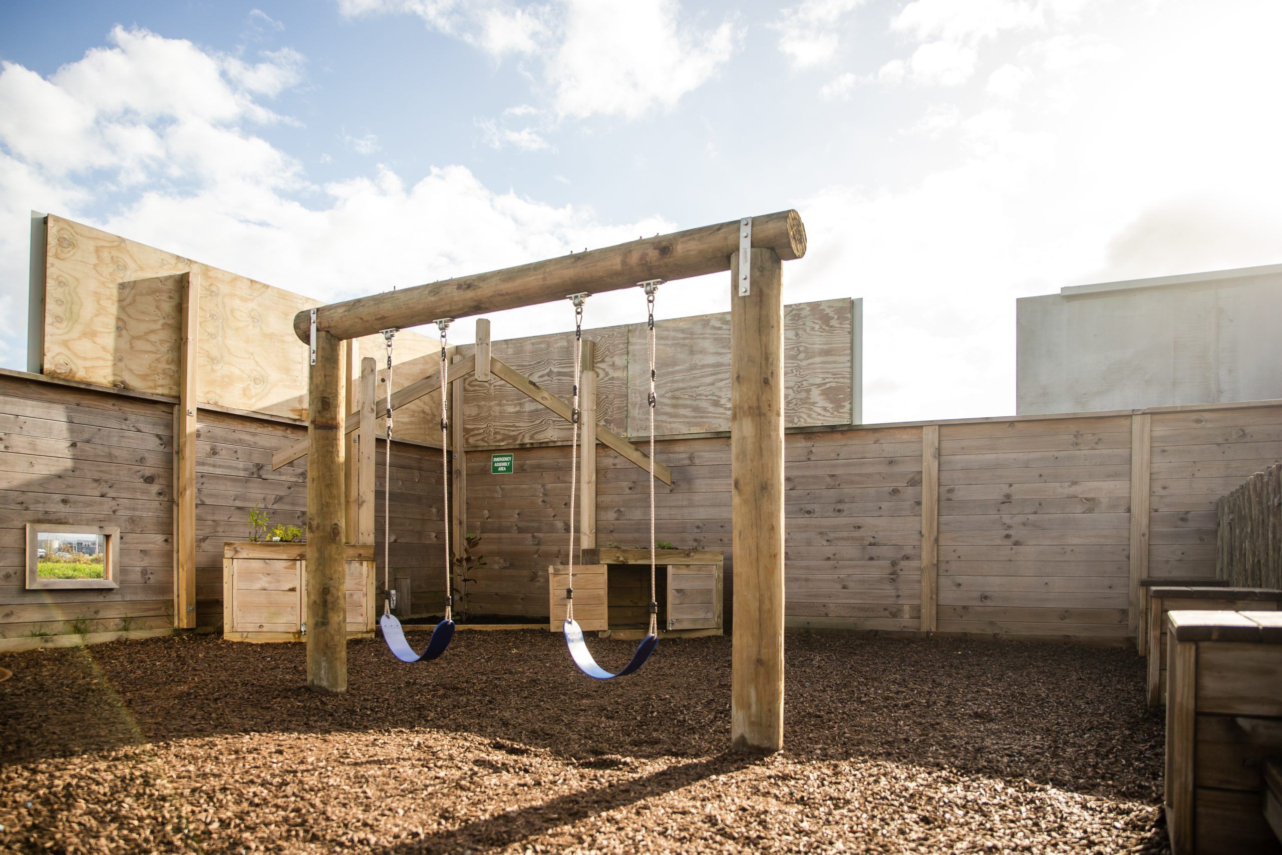 Nurture and Bloom | Outdoor wooden swings in one of our playgrounds