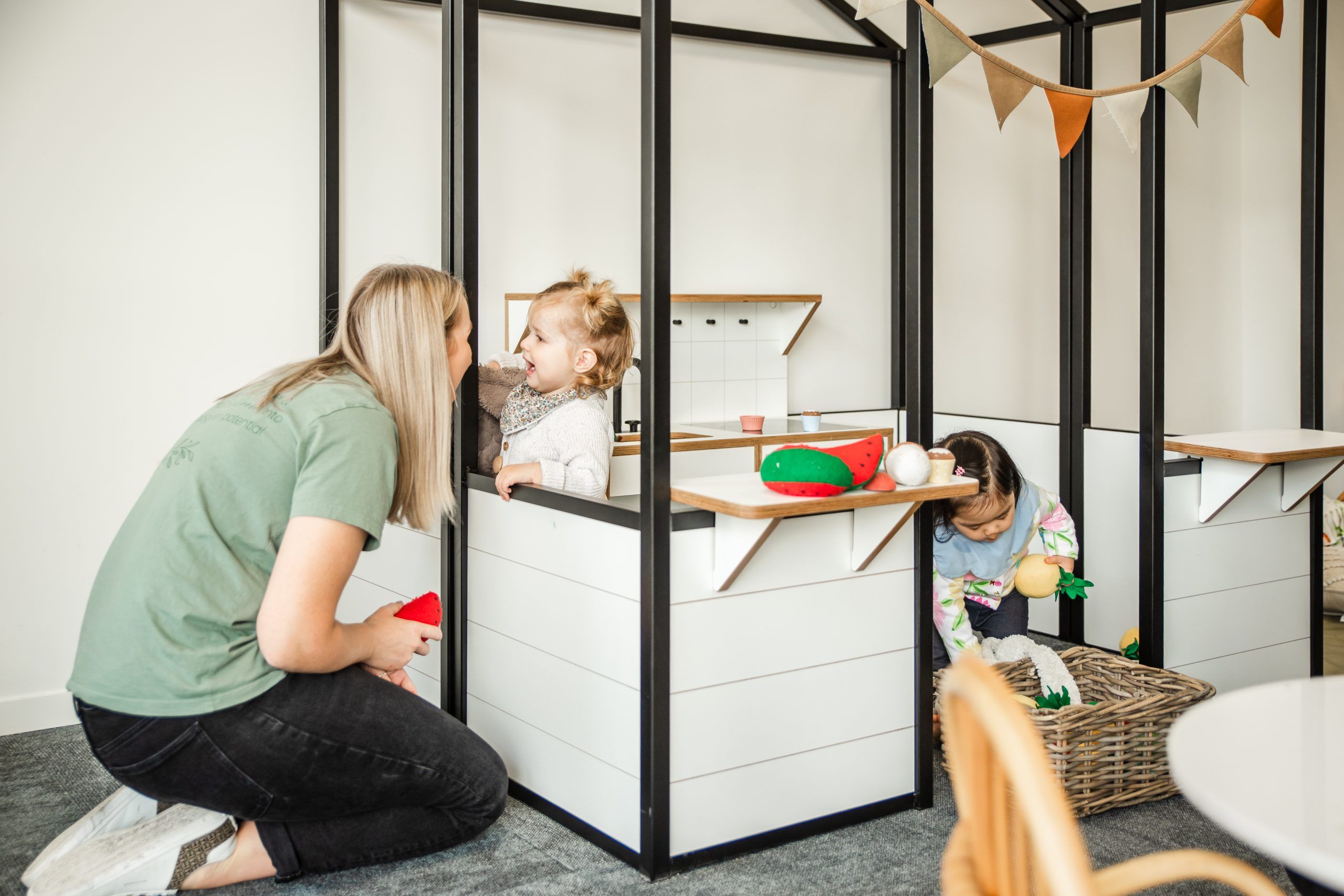 Nurture and Bloom |Children playing in one of our play houses with kitchen
