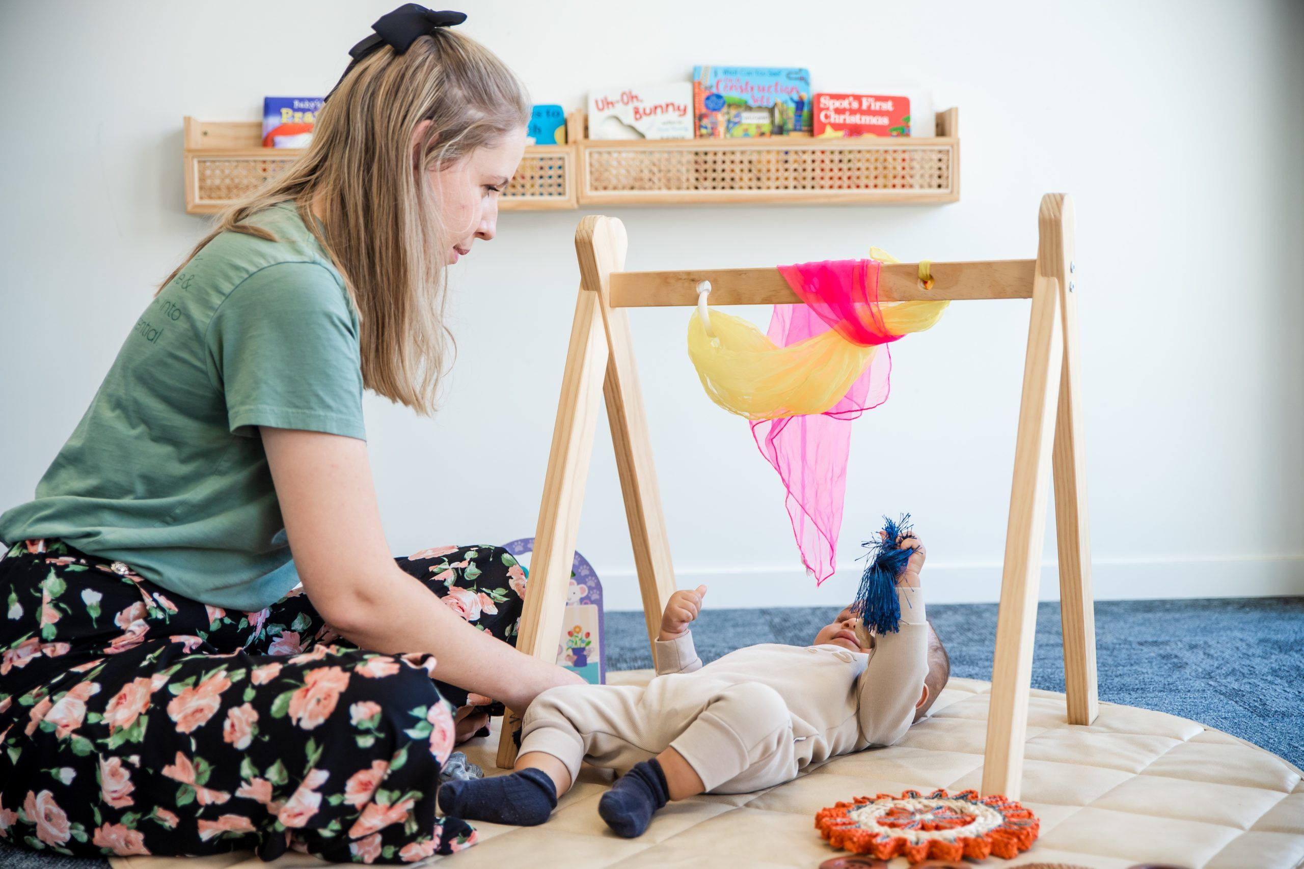 Nurture and Bloom | Teacher playing with baby