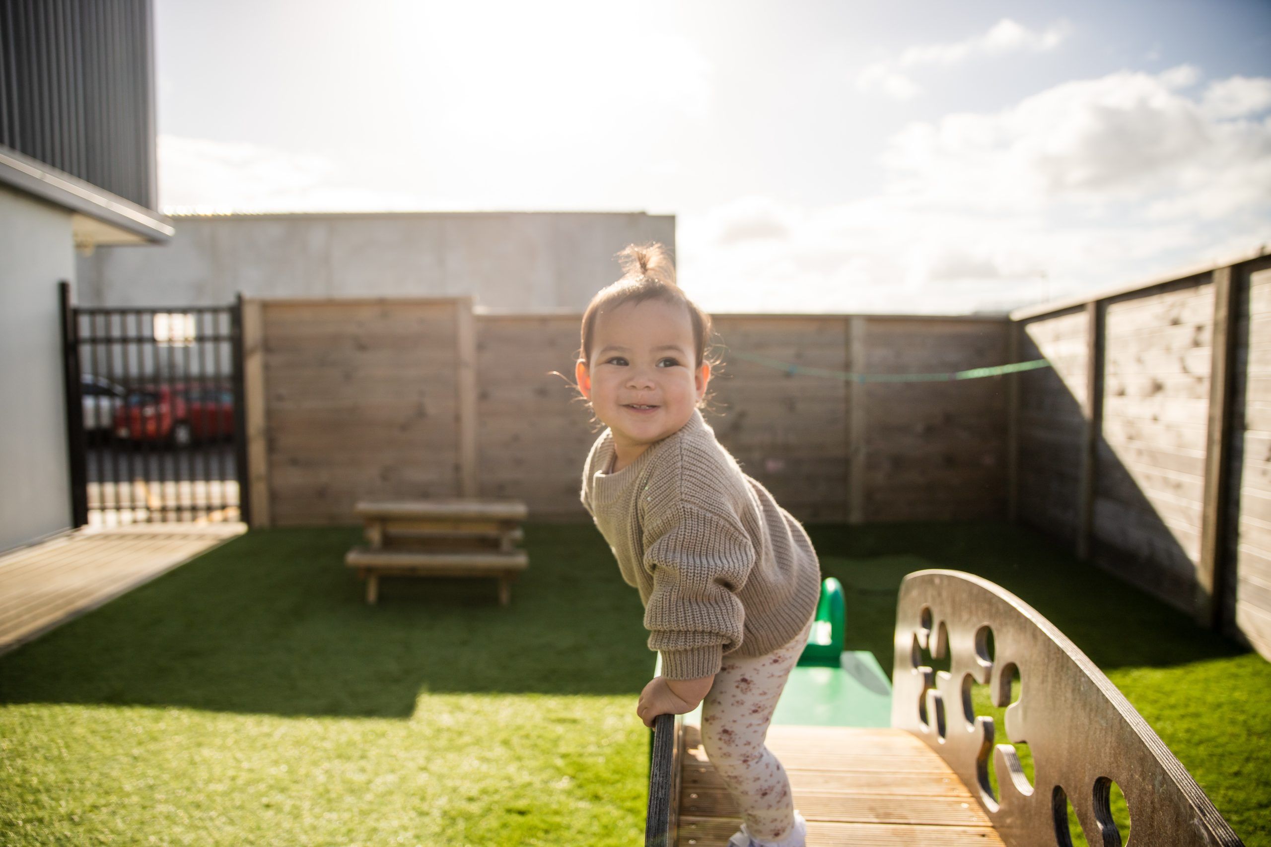 Nurture and Bloom | Child playing on outdoor play equipment