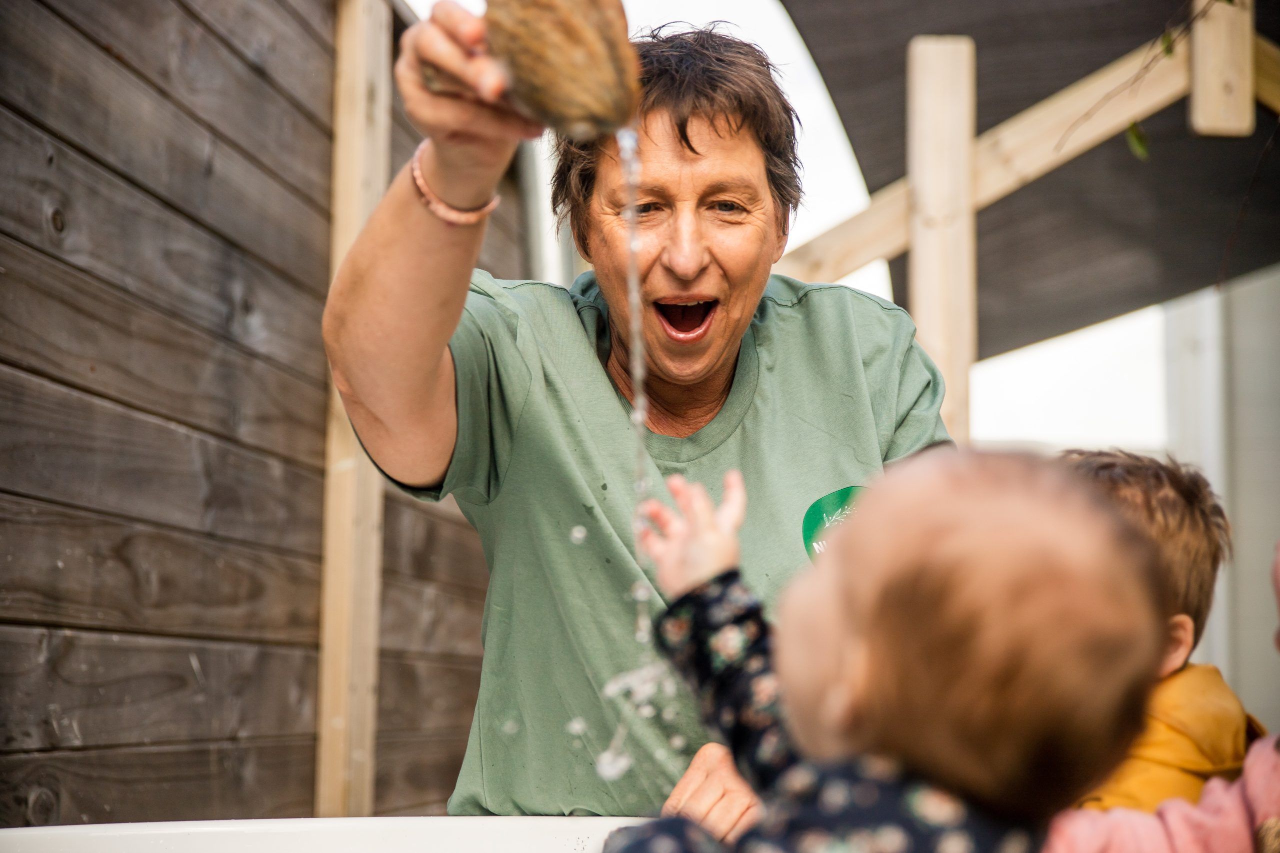 Nurture and Bloom | Teacher showing waterplay to kids