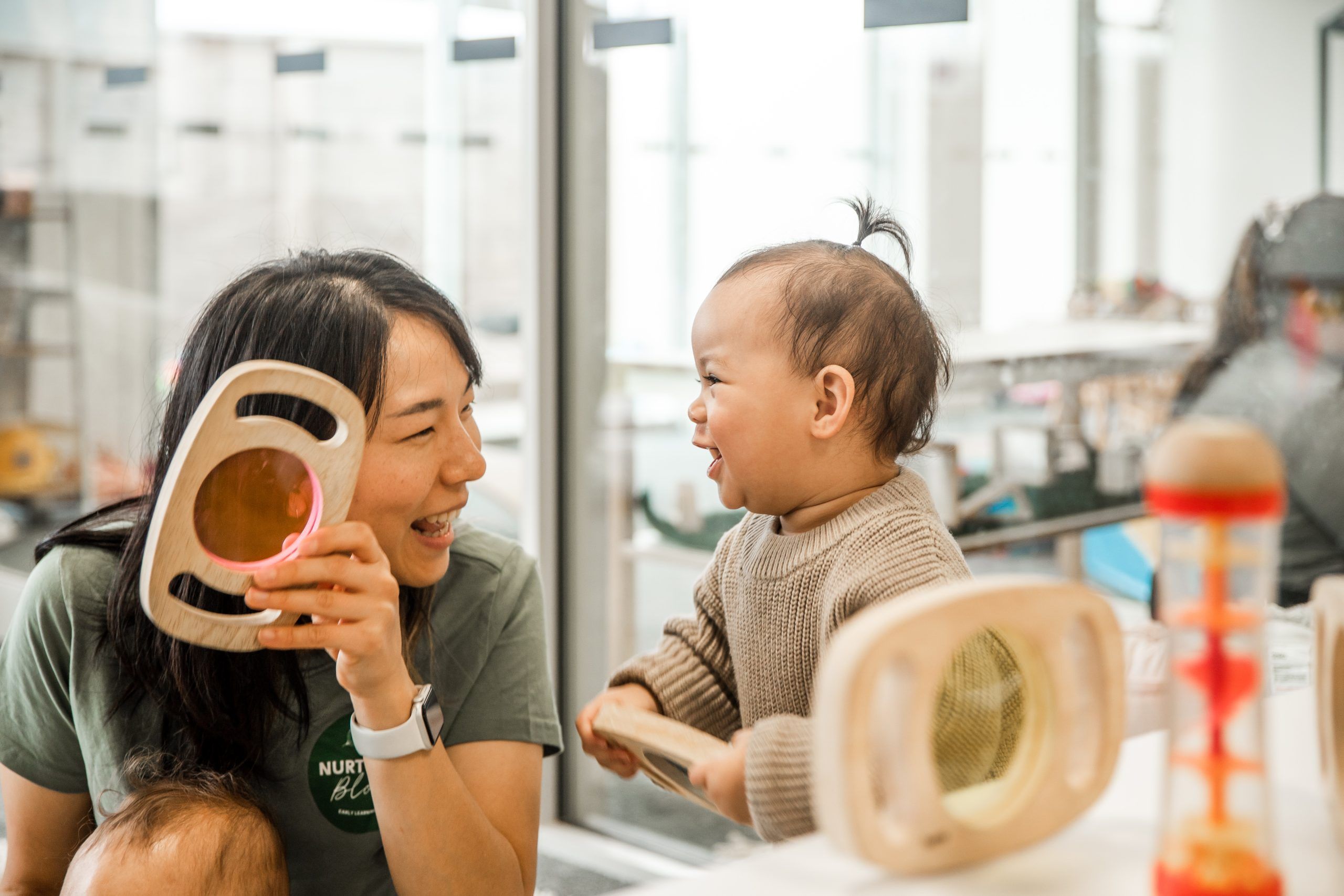 Nurture and Bloom | Teacher with child playing with curistic play