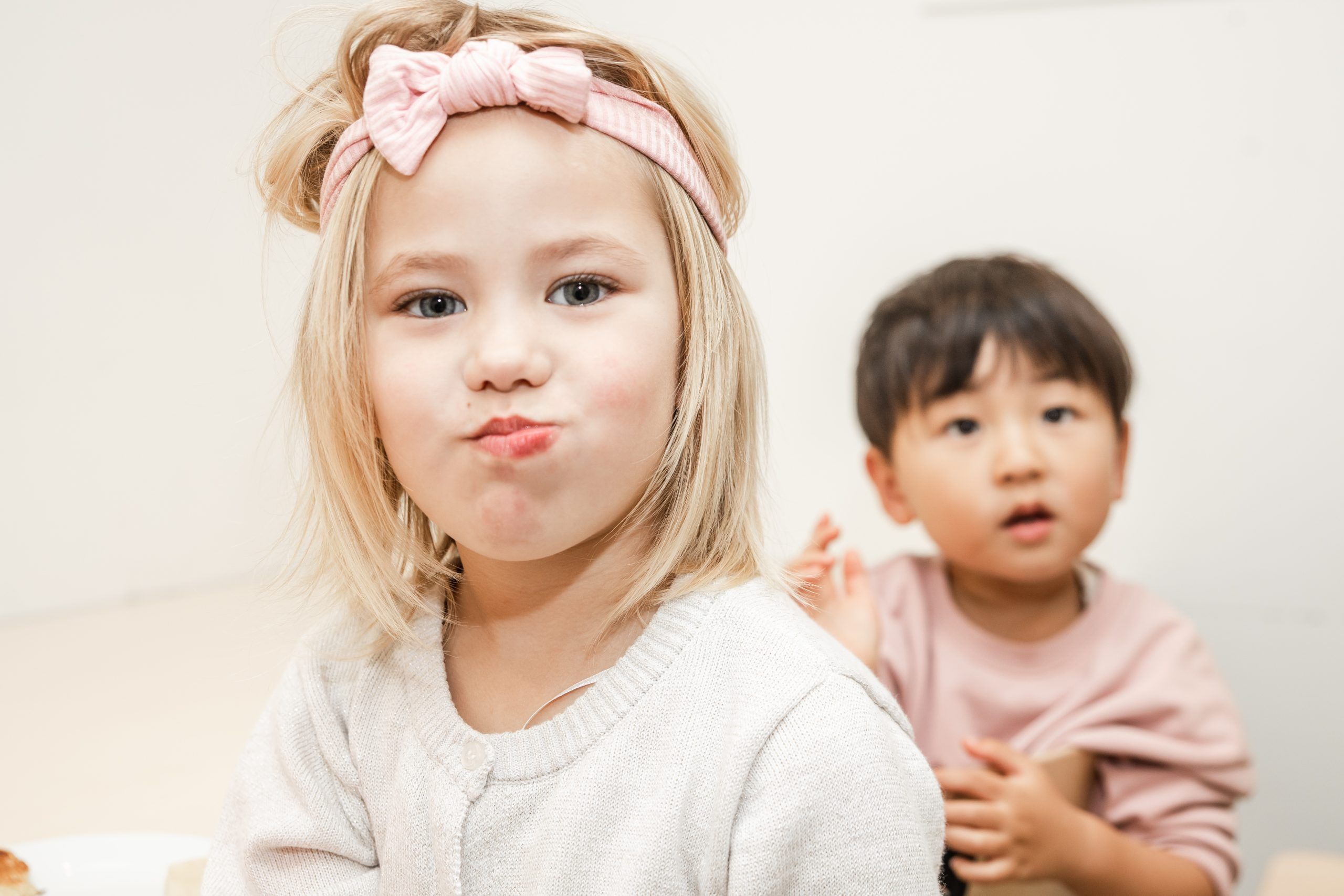 Nurture and Bloom | Kids making faces to camera and teacher while eating
