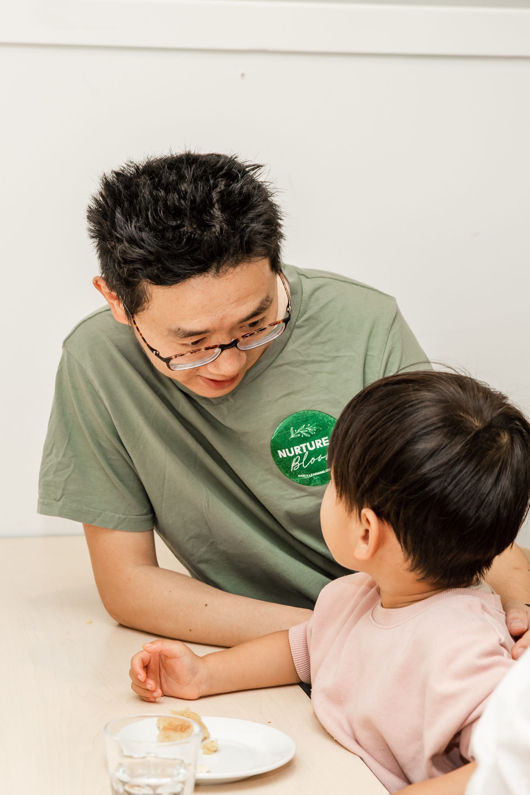 Nurture and Bloom | Teacher talking with kid eating morning tea