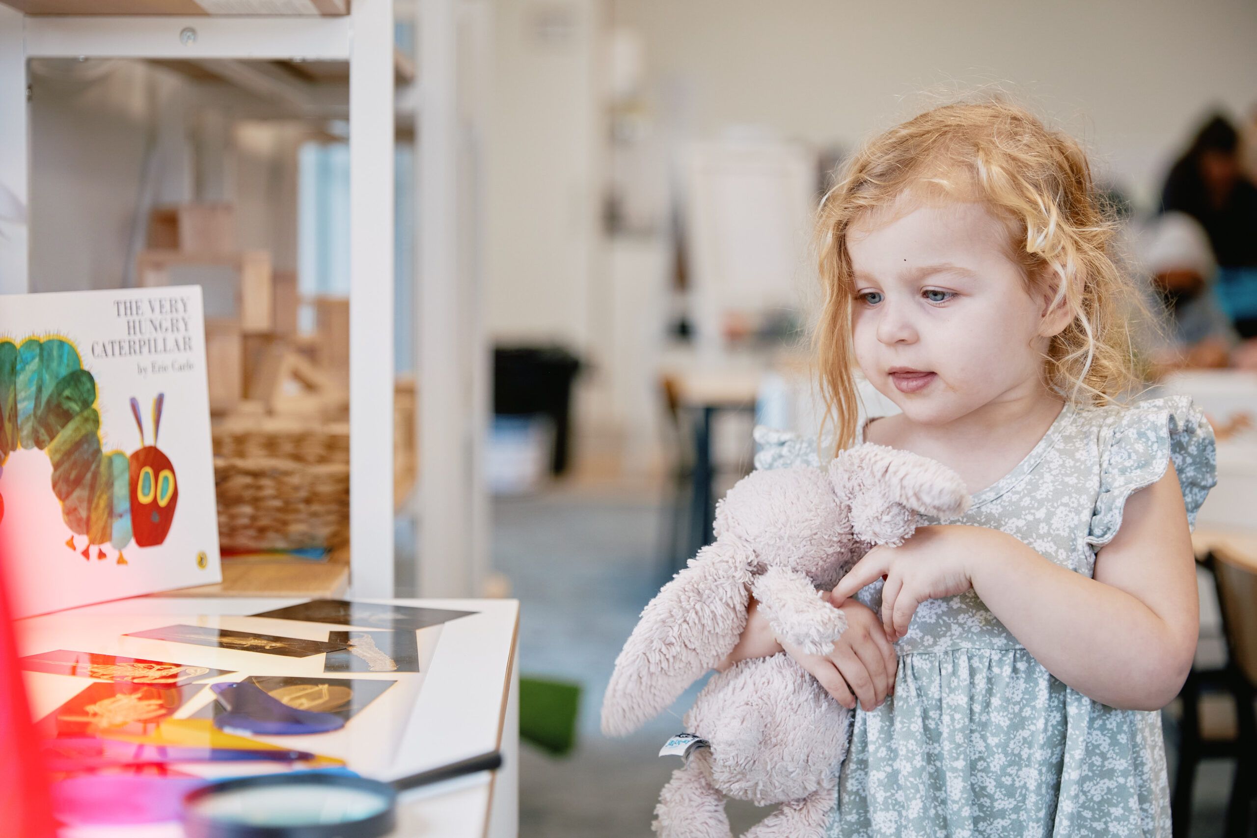 Nurture & Bloom | Child with soft toy enjoying some of our books