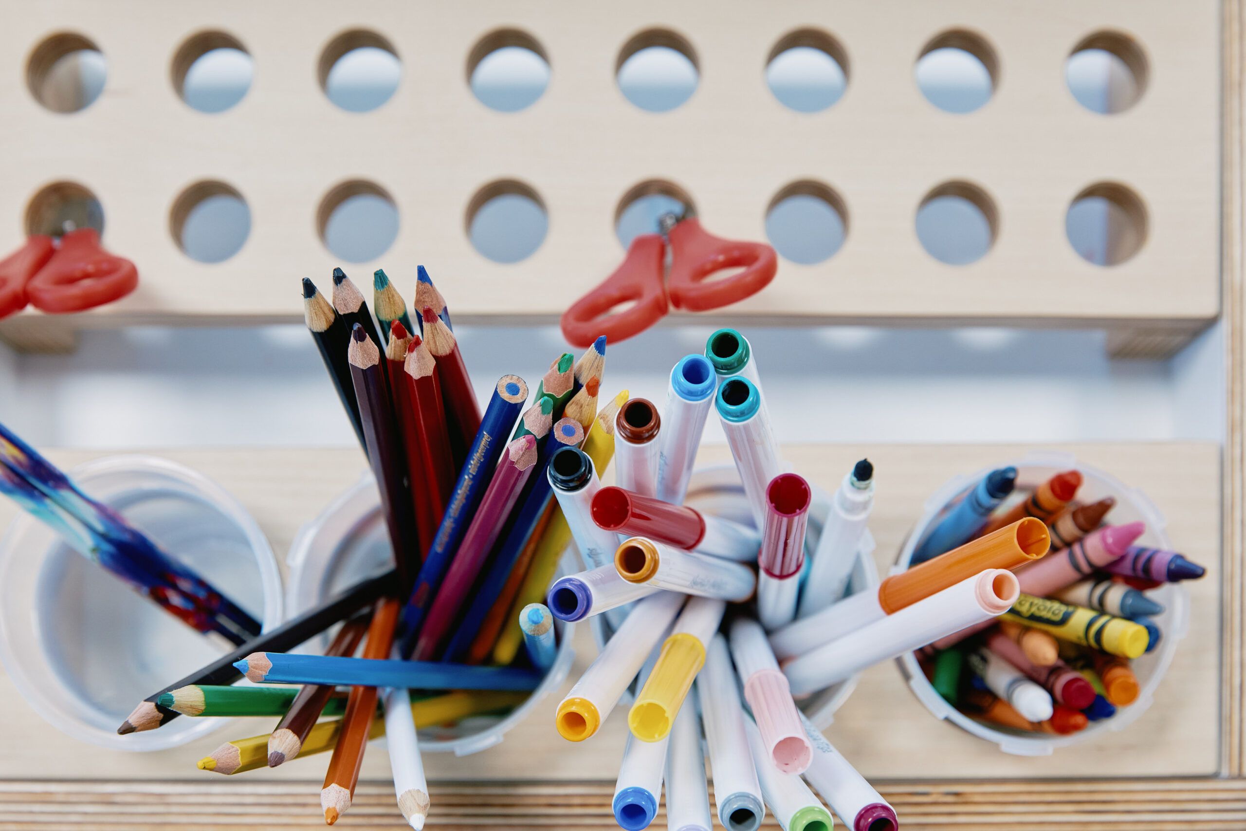 Nurture & Bloom | Pencils, pens, crayons, and child-friendly scissors in our art area