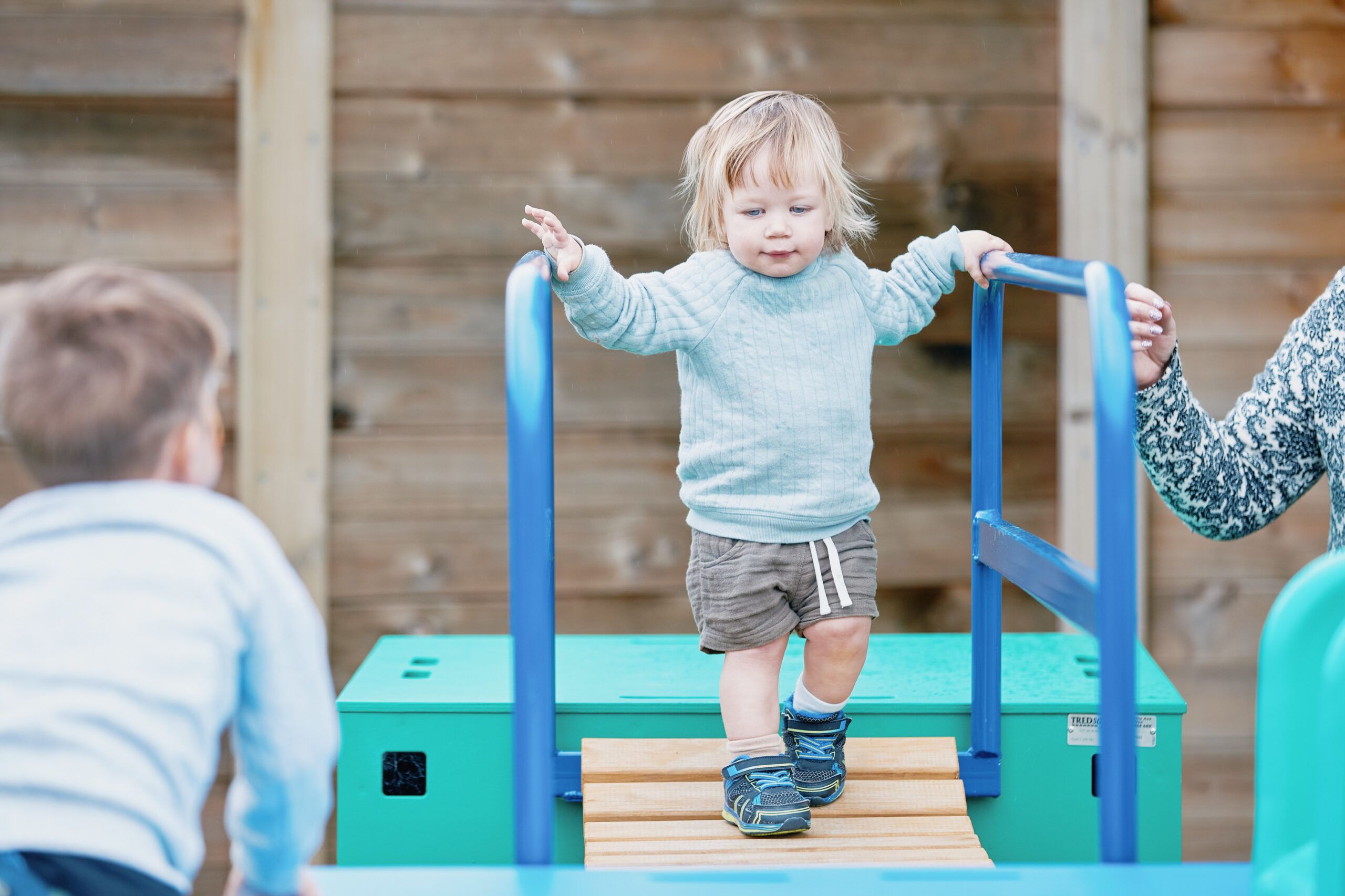 Nurture & Bloom | Child enjoying playing on the outdoor bridge equipment