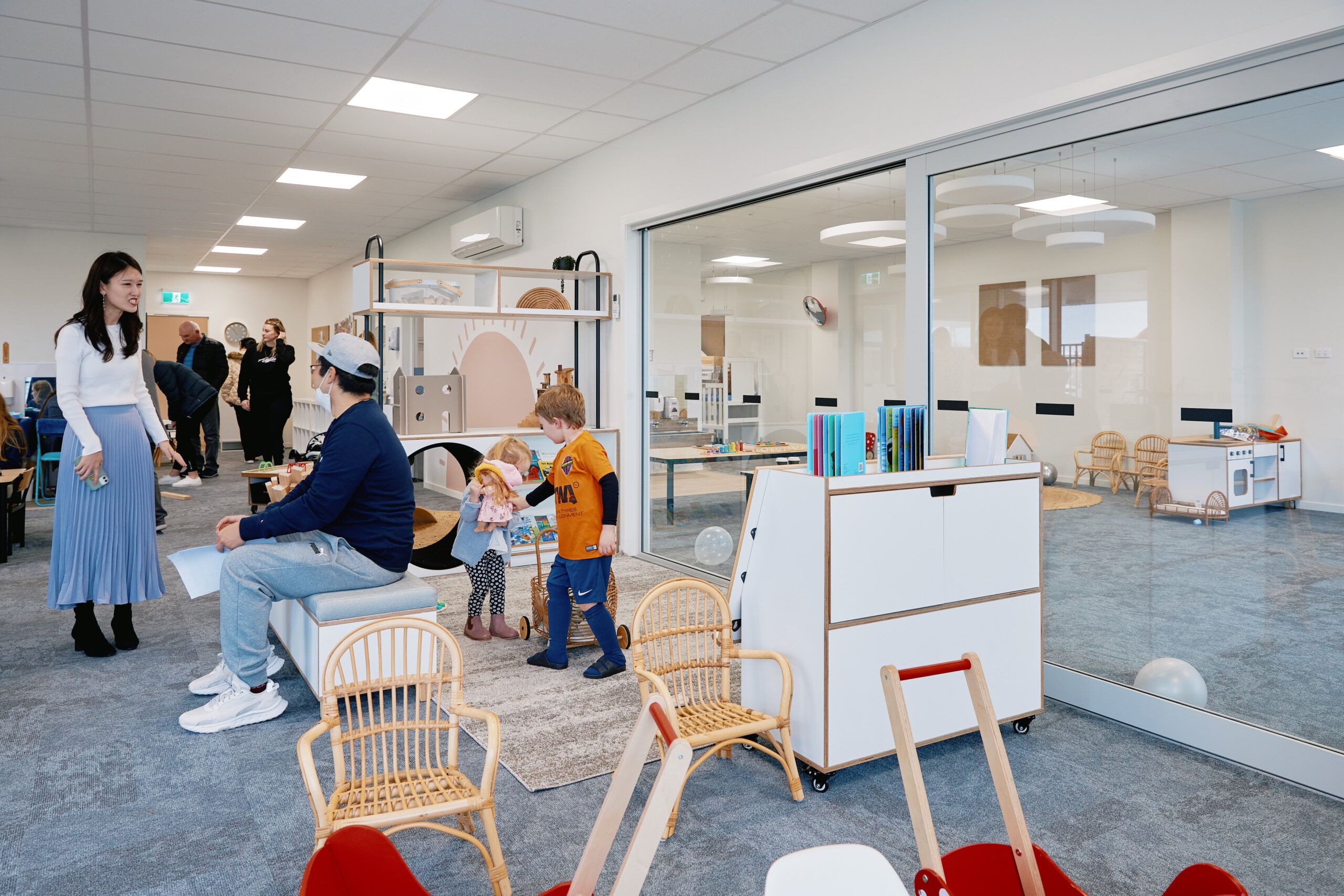 Nurture & Bloom | Children playing with home-based learning toys, teachers & parents chatting